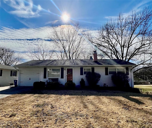 ranch-style house featuring driveway, brick siding, a chimney, and an attached garage