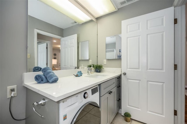 bathroom with tile patterned floors, visible vents, washer / dryer, and vanity