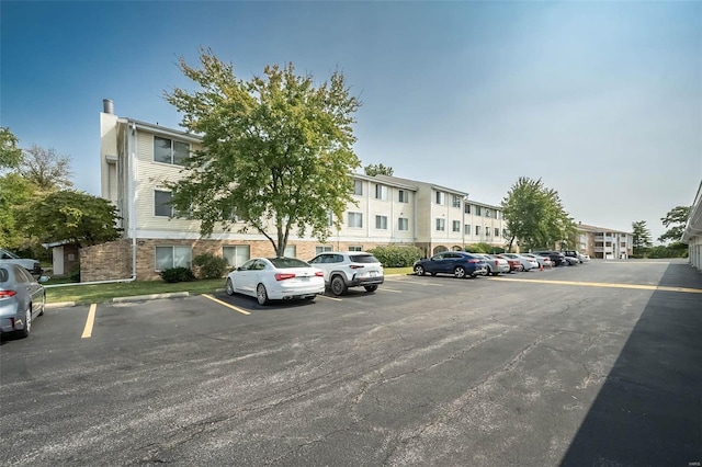 uncovered parking lot with a residential view