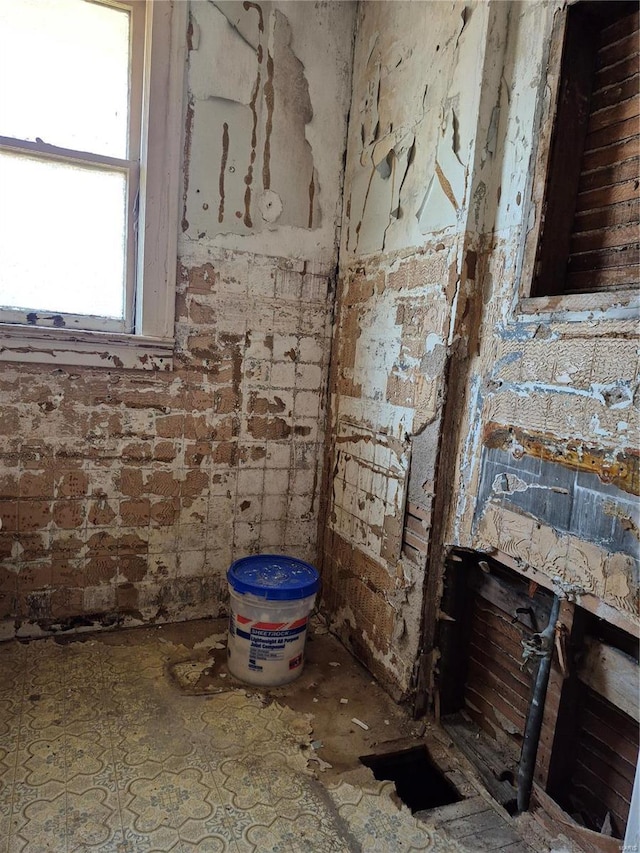 interior space featuring brick wall