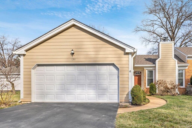 single story home with driveway, a chimney, and a garage