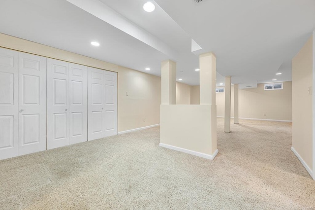 finished basement with visible vents, recessed lighting, baseboards, and carpet floors