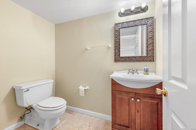 bathroom with tile patterned floors, toilet, vanity, and baseboards