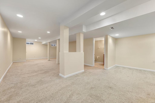 finished below grade area with visible vents, recessed lighting, and carpet floors