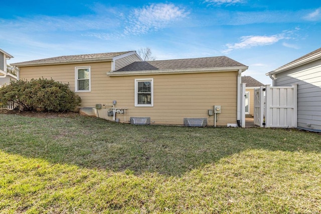 rear view of house with a yard