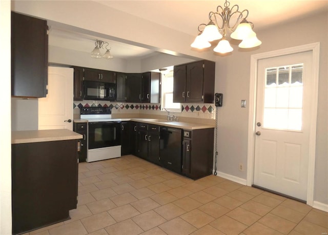 kitchen with black appliances, a notable chandelier, light countertops, and a sink