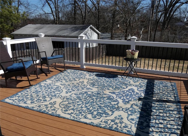 deck featuring a storage unit and an outdoor structure