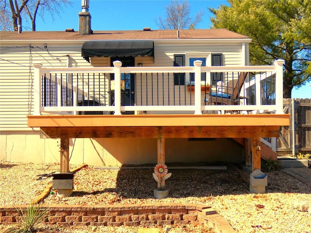 rear view of property featuring a wooden deck