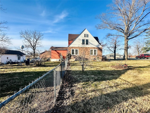 view of front of house with a fenced backyard and a front lawn