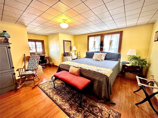 bedroom with baseboards and wood finished floors