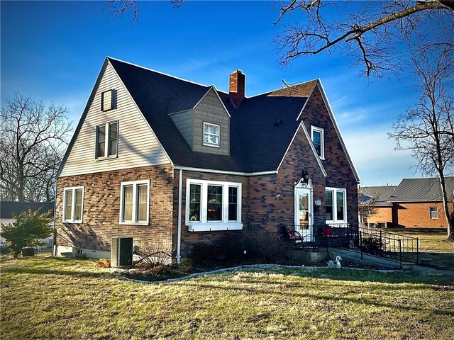 exterior space with a lawn, brick siding, and a chimney