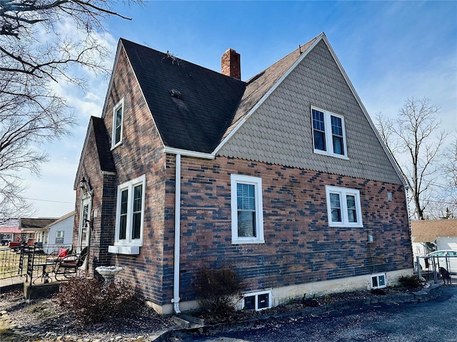 view of property exterior with a chimney