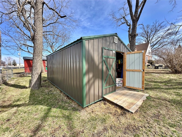 view of shed featuring fence