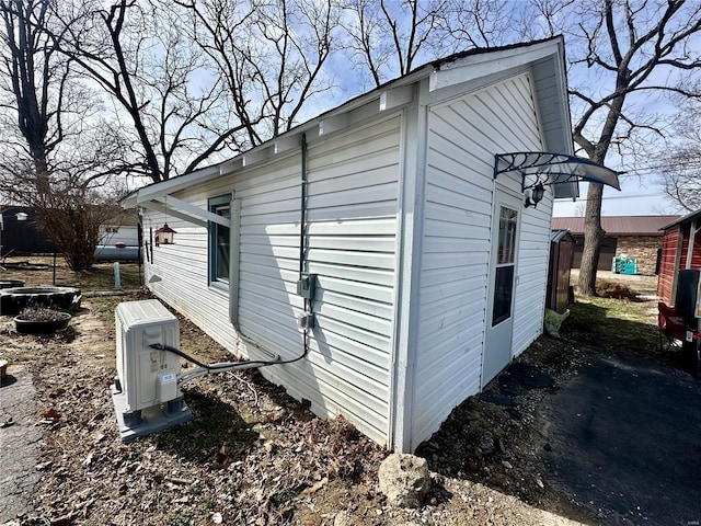 view of side of home with ac unit