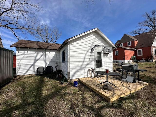 rear view of house featuring a deck and a wall mounted AC