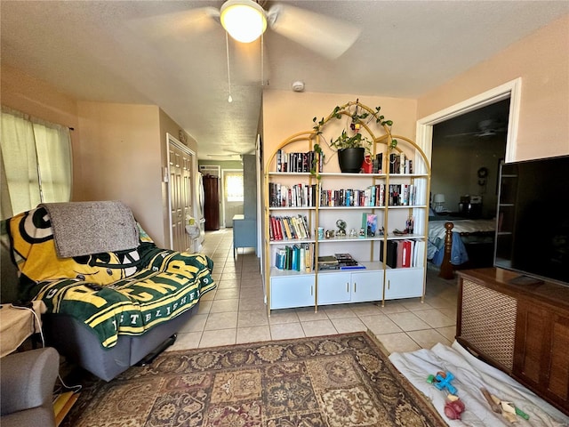 sitting room with tile patterned flooring and ceiling fan