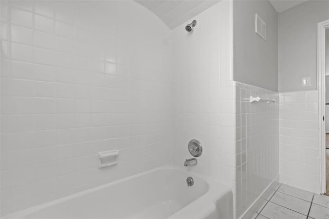 bathroom featuring tile patterned floors, visible vents, tile walls, and shower / bathing tub combination