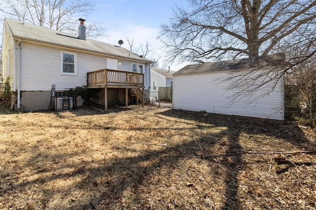 back of property featuring a chimney, a wooden deck, stairs, and central AC