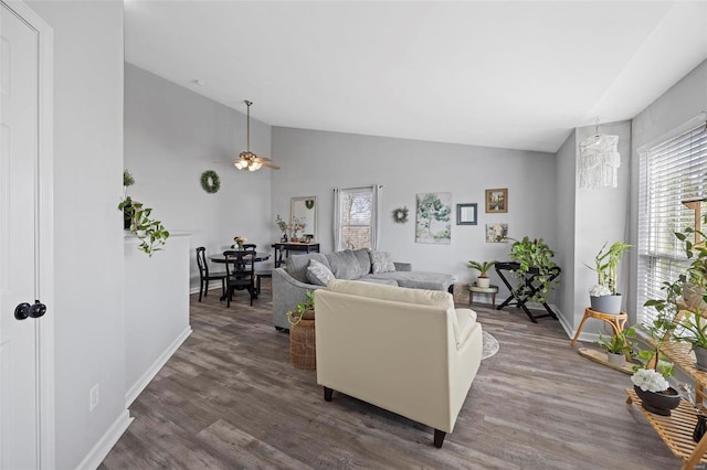 living area featuring dark wood finished floors, lofted ceiling, and plenty of natural light