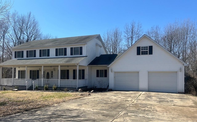 view of front facade with a porch, driveway, and a garage