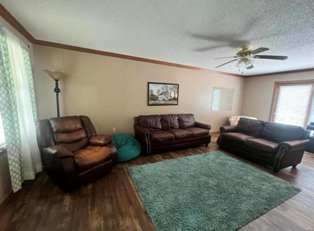 living area with a ceiling fan, a textured ceiling, wood finished floors, and crown molding