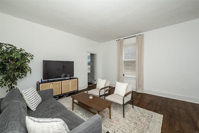 living room featuring baseboards and wood finished floors