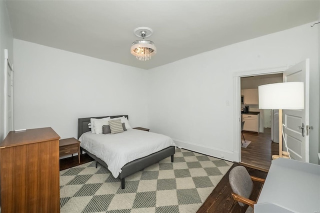 bedroom with baseboards and wood finished floors