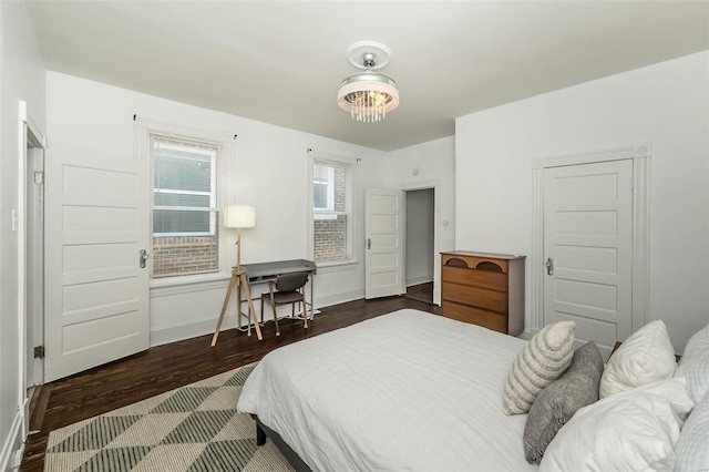 bedroom featuring baseboards and wood finished floors