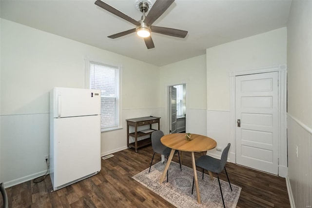 dining area featuring ceiling fan and dark wood finished floors