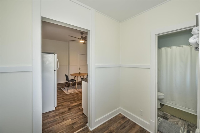 hall featuring dark wood finished floors and baseboards