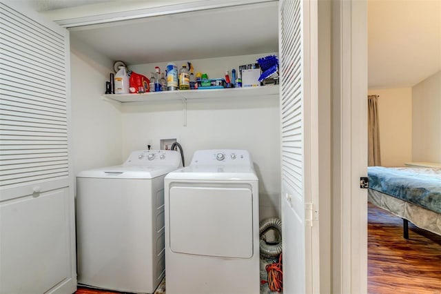 laundry room featuring laundry area, independent washer and dryer, and wood finished floors