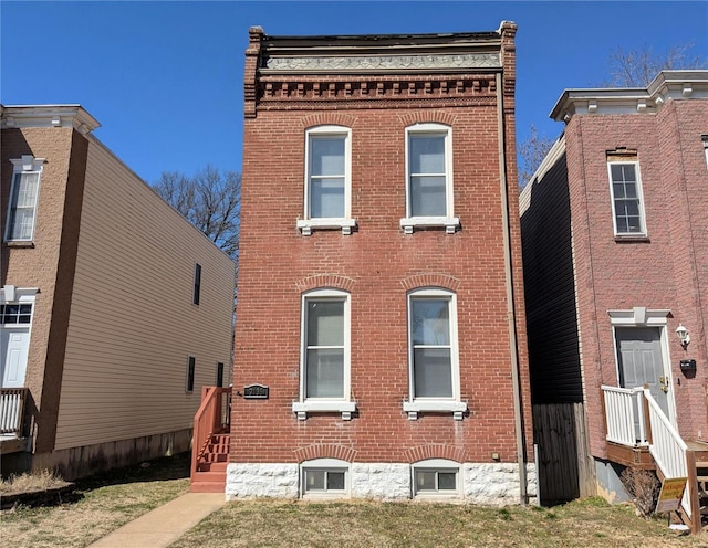 italianate home featuring brick siding