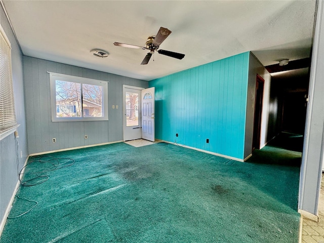 carpeted spare room featuring a ceiling fan, baseboards, and visible vents