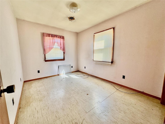 unfurnished room with tile patterned floors, visible vents, and baseboards