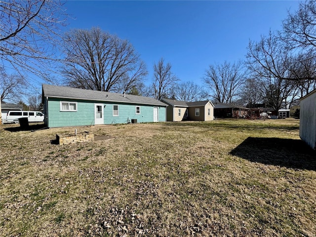 rear view of house featuring a lawn