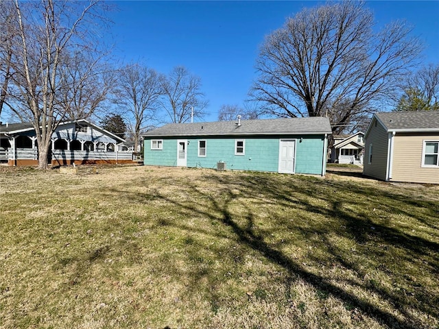 rear view of house featuring a lawn