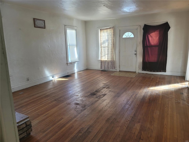 entryway featuring visible vents, baseboards, and hardwood / wood-style flooring