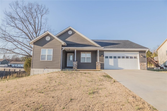 view of front of house featuring stone siding, concrete driveway, and an attached garage