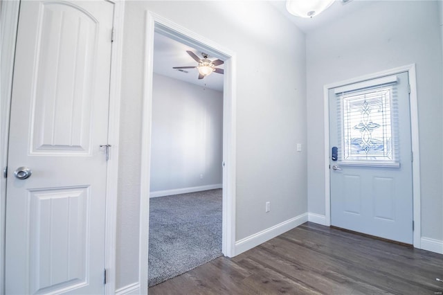 entryway featuring a ceiling fan, dark wood-type flooring, and baseboards