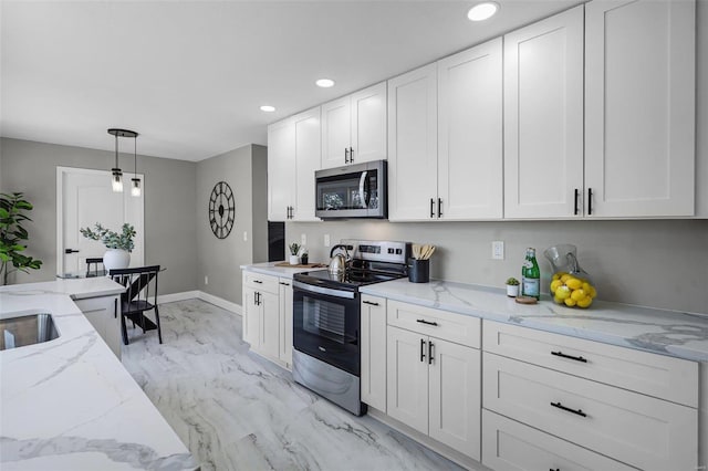 kitchen with marble finish floor, appliances with stainless steel finishes, white cabinets, and hanging light fixtures