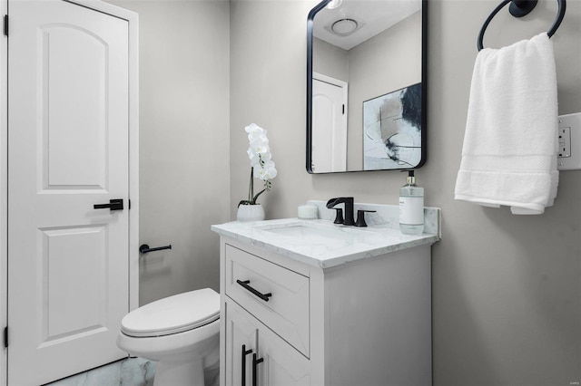 bathroom with toilet and vanity