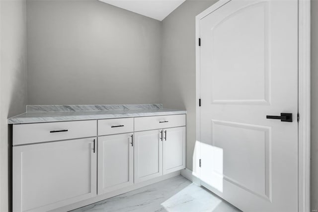 clothes washing area featuring marble finish floor