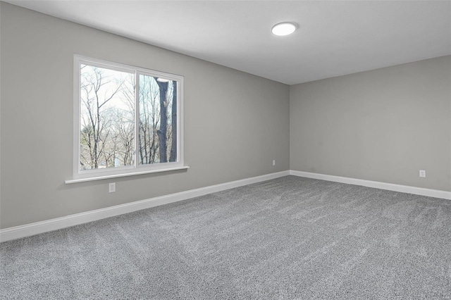 carpeted empty room with baseboards