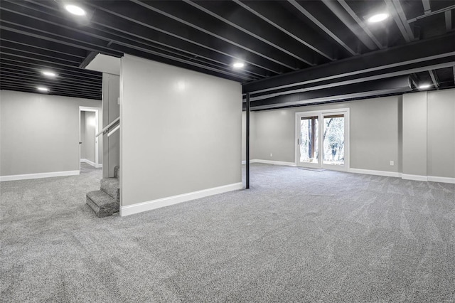 basement with stairway, baseboards, and carpet