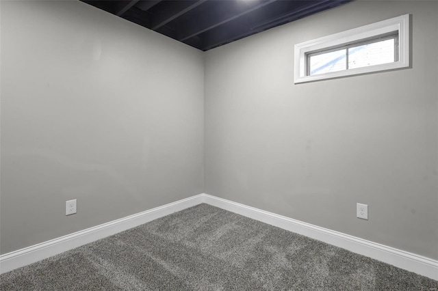 carpeted spare room with baseboards