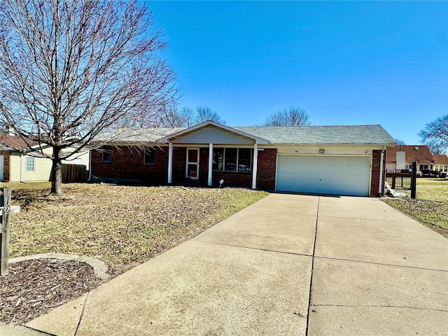 single story home with a garage, brick siding, and driveway