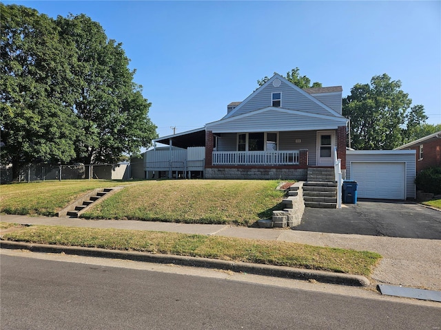 view of front of house featuring covered porch, driveway, stairs, and a front yard