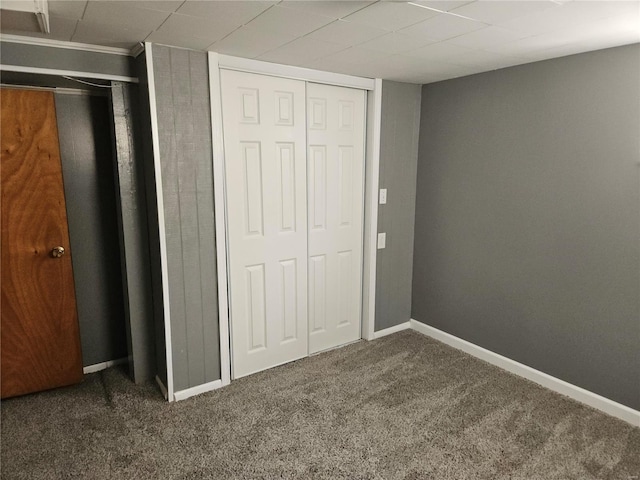 unfurnished bedroom featuring carpet flooring and baseboards