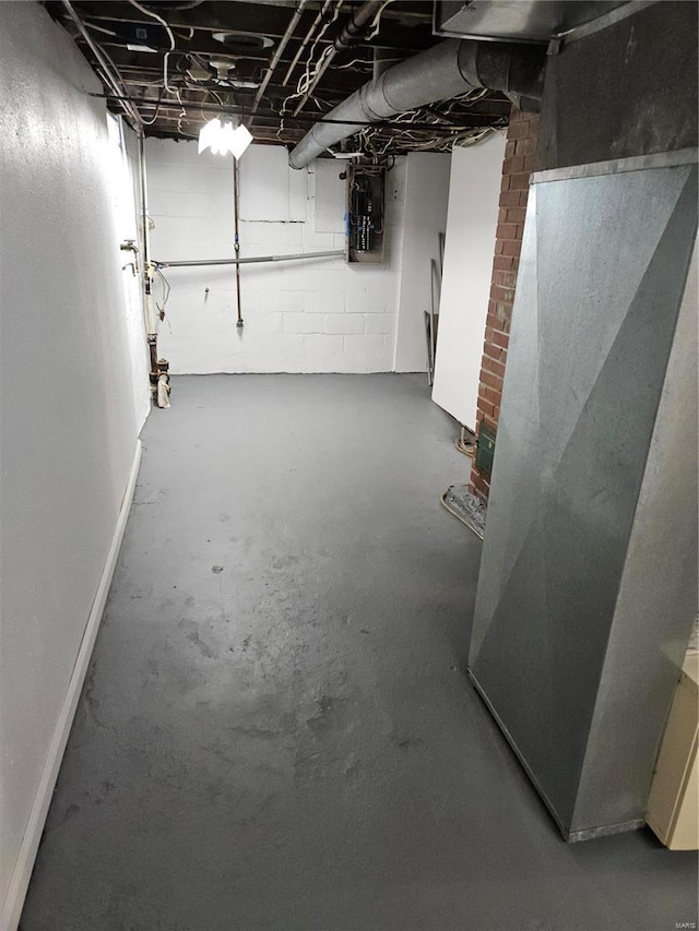 unfinished below grade area featuring heating unit and baseboards