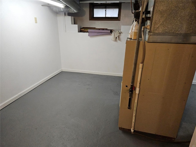 basement featuring heating unit and baseboards